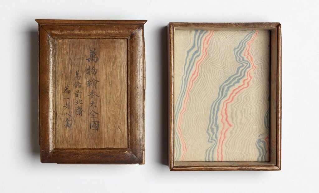 Paulownia-wood storage box for the 103 drawings of Katsushika Hokusai's (1760–1849) The Great Picture Book of Everything, inscribed with the title and name of the artist. Wood, paper, silk textile, 1820s–1840s. From Hokusai Free Download